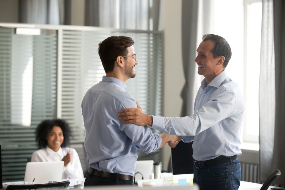 two males shaking hands in a professional office setting