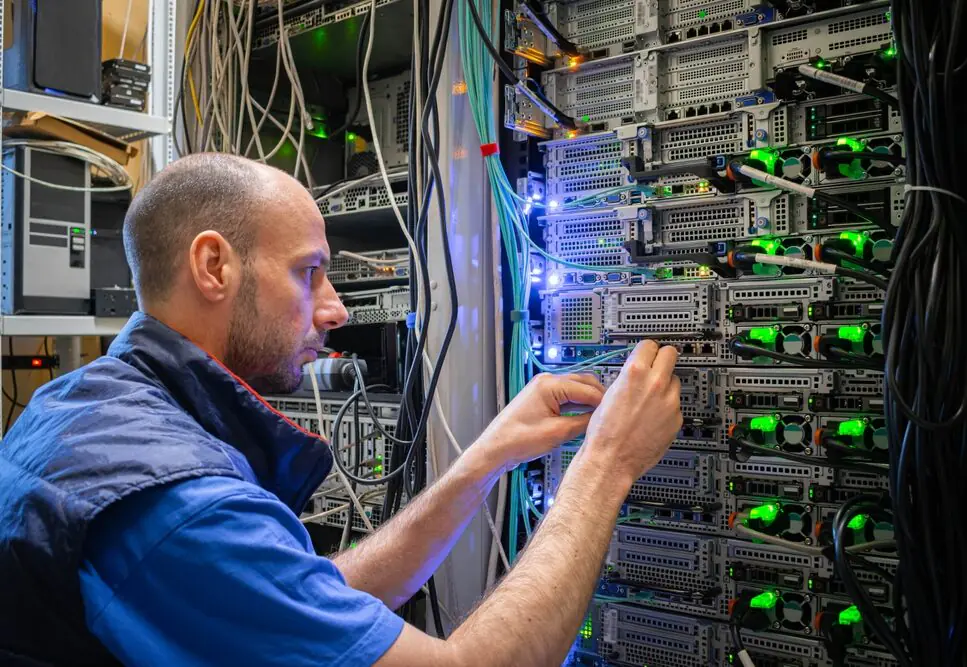 Male IT technician working on a rack in a data centre