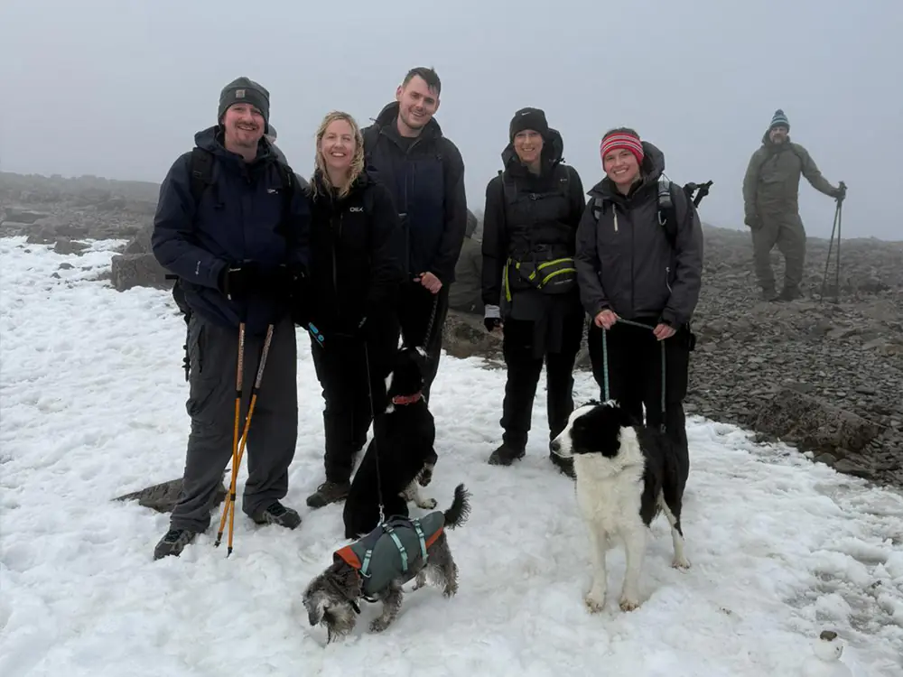 Two males and three females smiling for a photo at the top of Ben Nevis