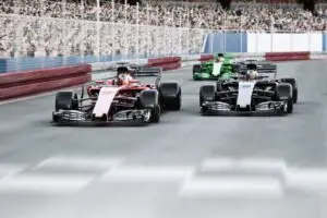 Three motor racing cars on a race track with crwods in the background