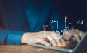 Person at laptop with digital icons displaying cloud NAC