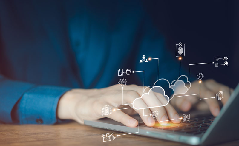 Person at laptop with digital icons displaying cloud NAC