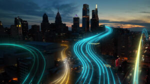 City skyline at night time that shows light across the roads