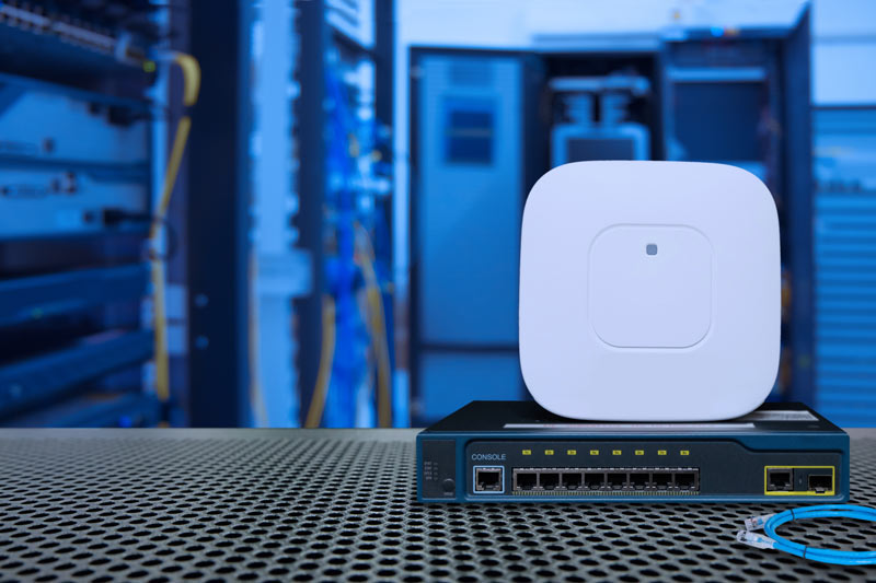 Closeup of wireless access point and switch in data centre
